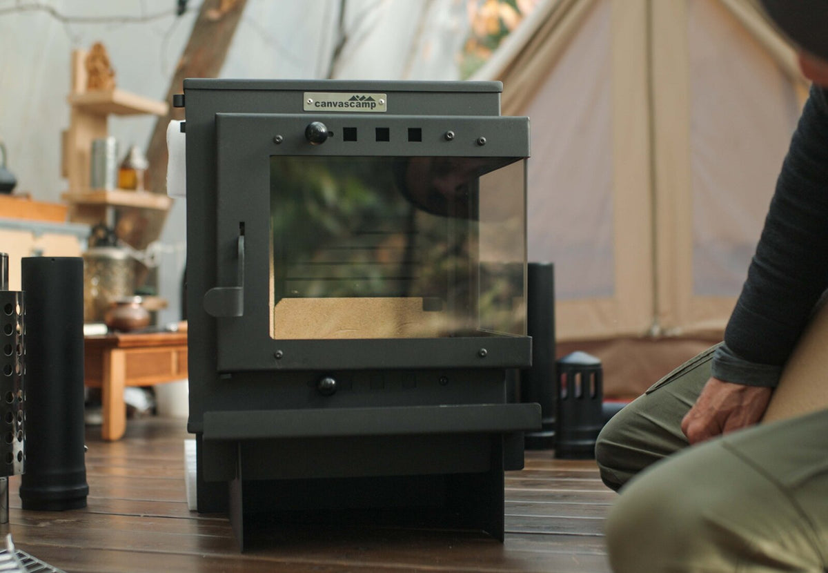 CanvasCamp Bison auf einem Holzboden in einem Canvaszelt, mit Glasscheibe an der Vorderseite
