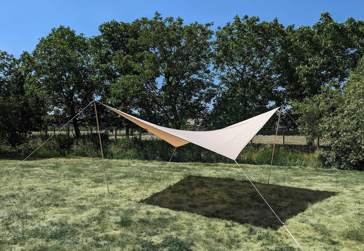 CanvasCamp Malu Vordach auf einer Wiese gespannt, mit Bäumen und Schatten darunter
