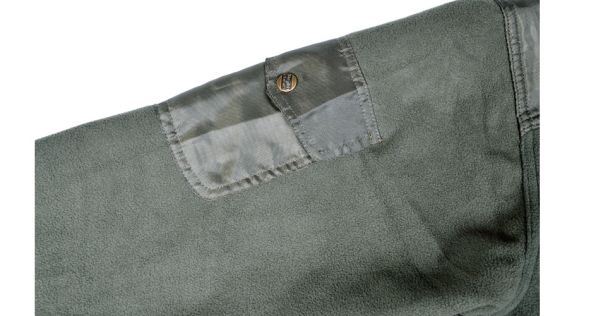 Stealth Gear Fleece2, Detail einer aufgenähten Tasche mit Druckknopf auf dem grünen Stoff