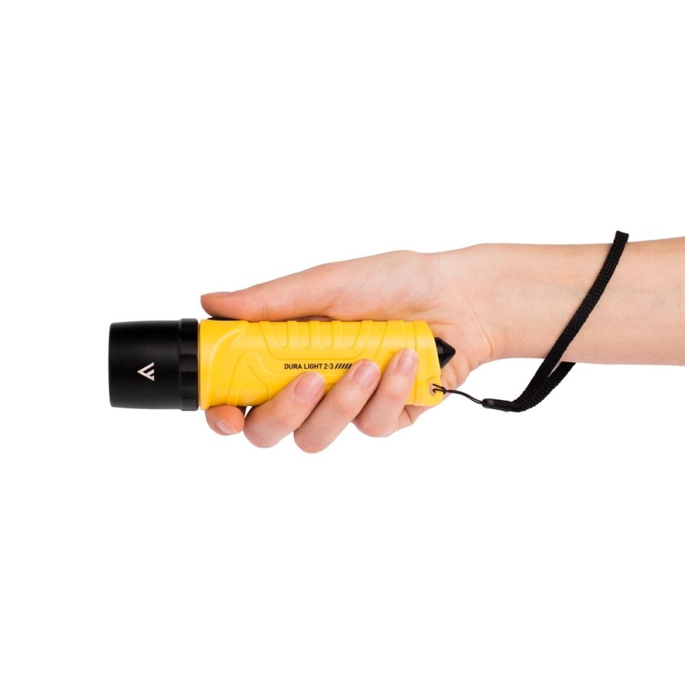 Mactronic Dura Light 2.3 gelbe Taschenlampe in einer Hand mit der schwarzen Handschlaufe